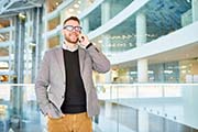 Businessman Speaking by Phone in Office Building